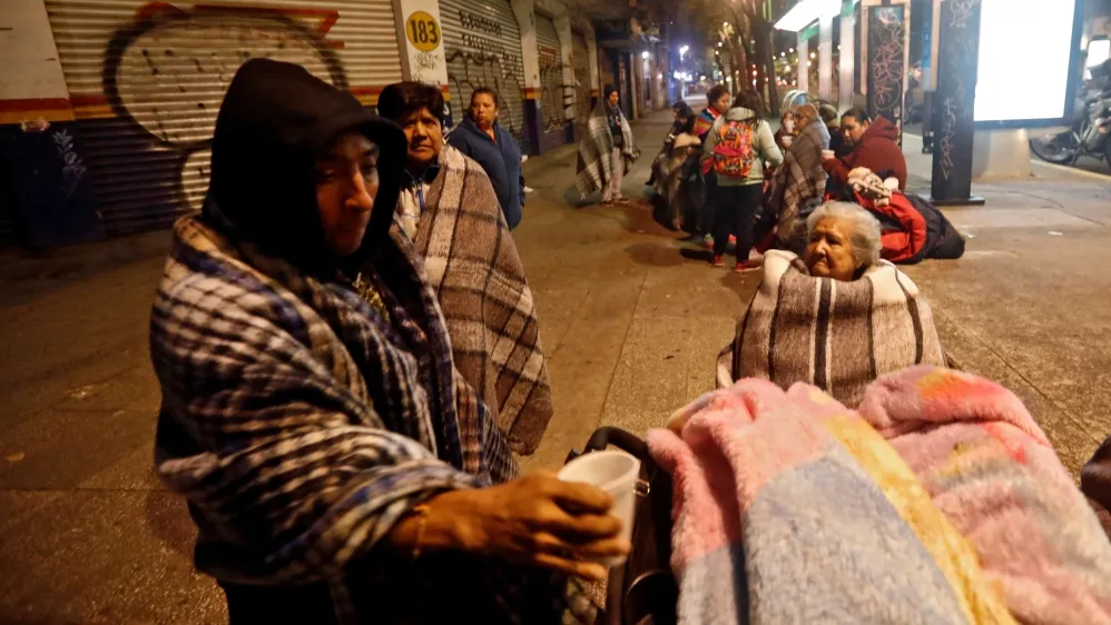 People gather on a street after the earthquake hit Mexico City