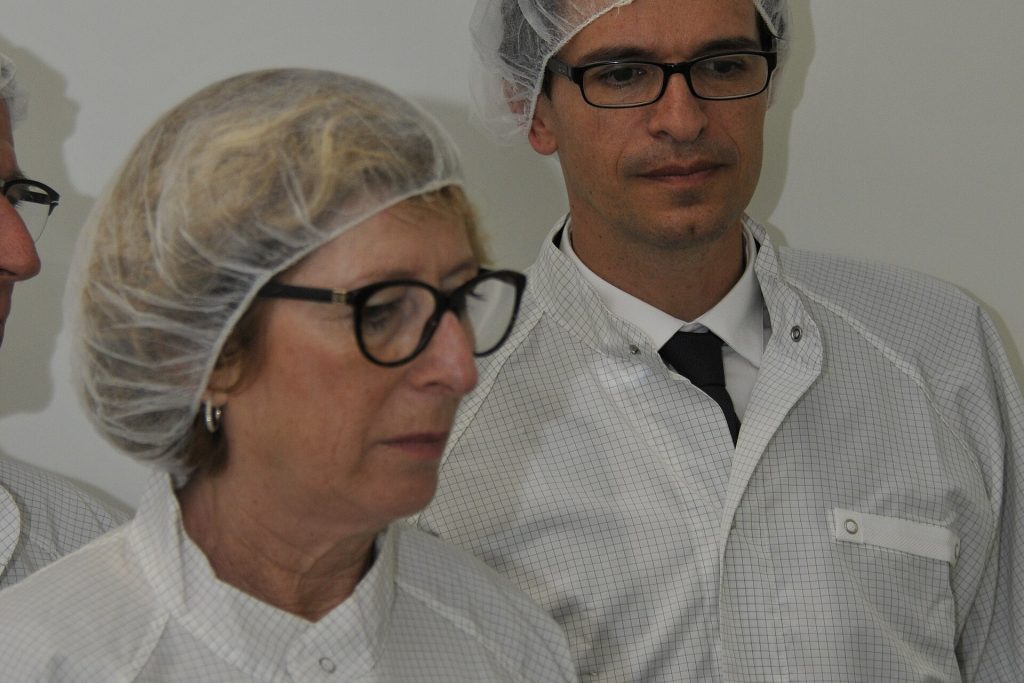Semiconductor factory cleanroom with engineers working on chip production
